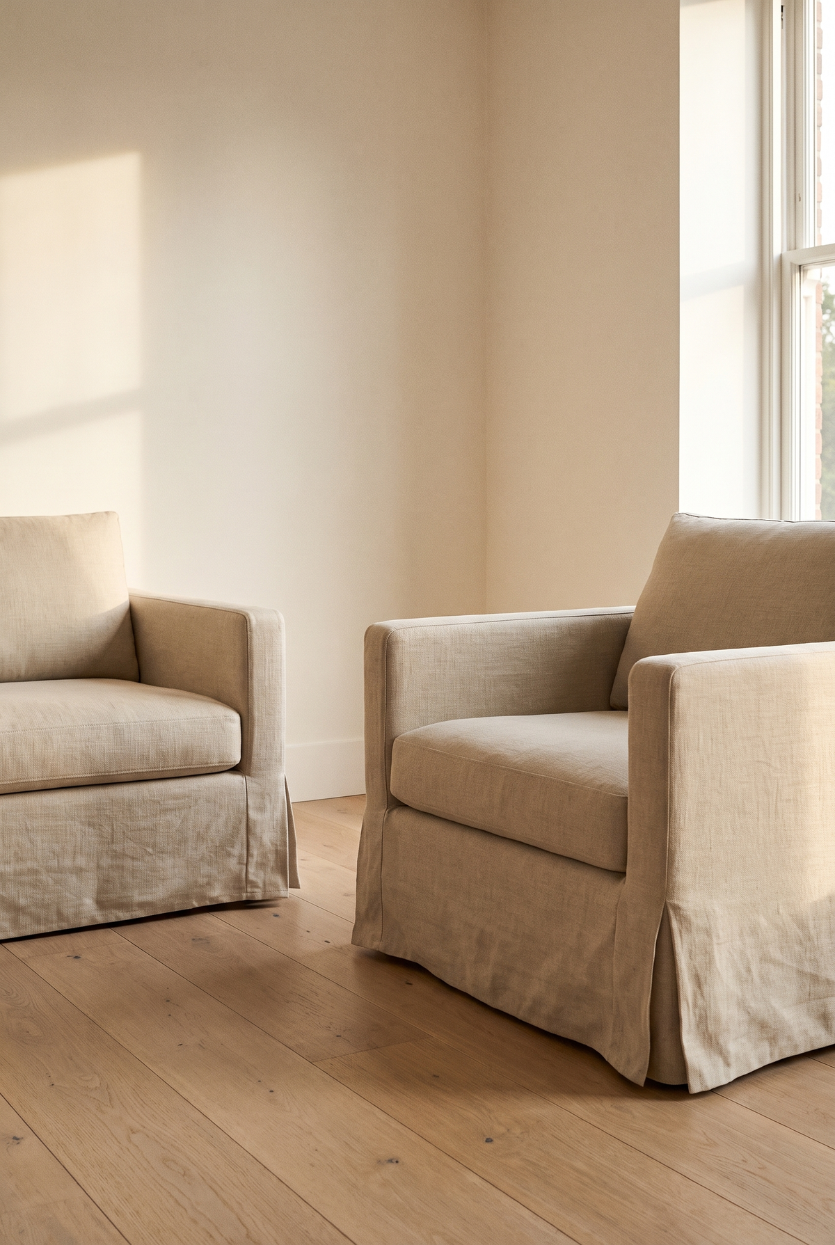 An armchair dressed in a fitted oat slipcover