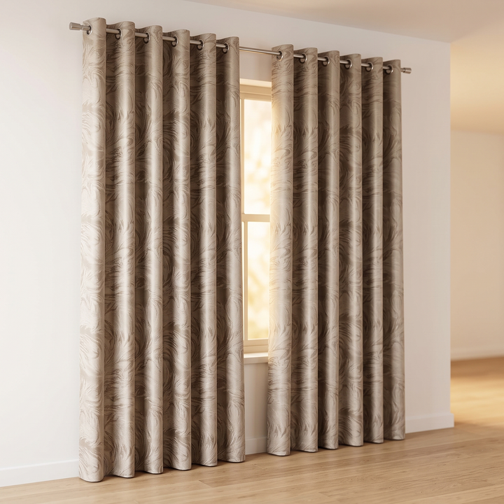 Patterned Curtain Panel – Abstract Leaf in Taupe – pair of eyelet curtains hung on a pole beside a sunlit window