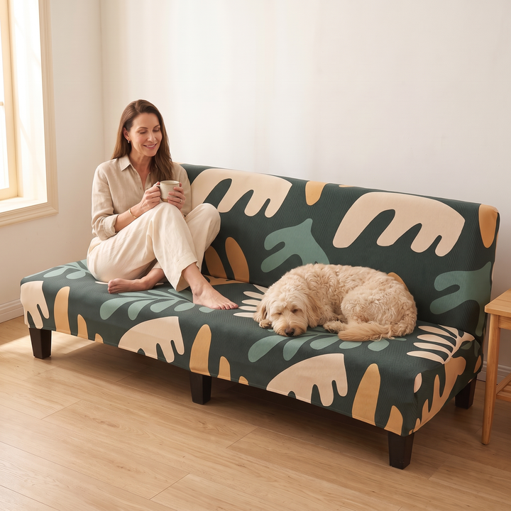 Stretch Futon Cover – Armless in Dark Green – Abstract Leaf – on a sofa with a woman and dog relaxing