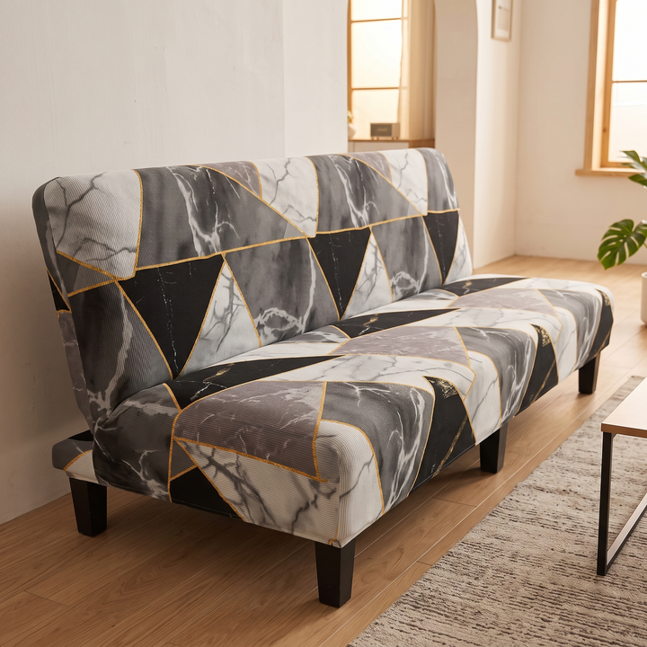 Stretch Futon Cover – Armless in Dark Gray – Marble Triangle – angled view with arched wall opening and coffee table corner
