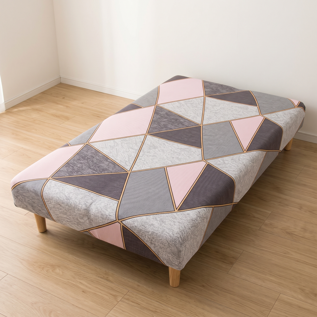 Stretch Futon Cover – Armless in Light Pink – Geometric – tucked into a corner where two white walls meet