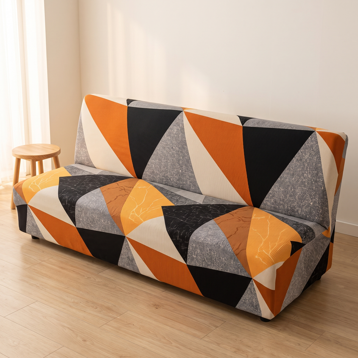Stretch Futon Cover – Armless in Orange – Triangle – angled view with round wooden stool at left end