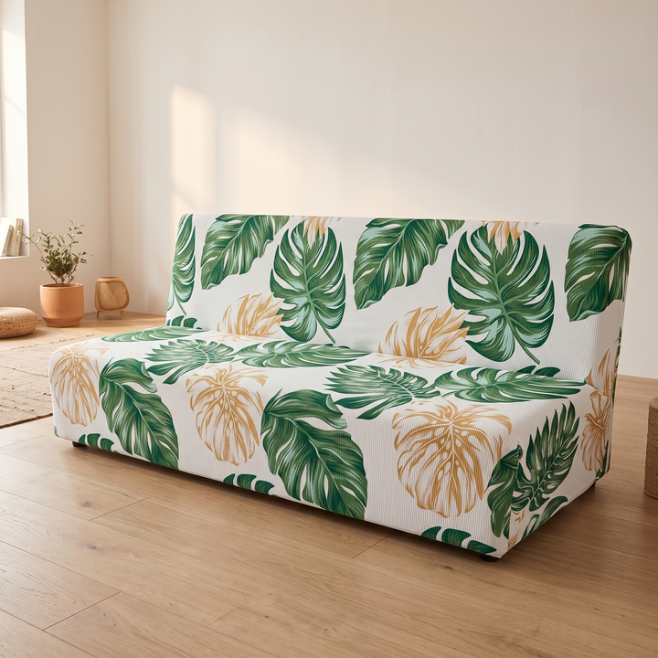 Stretch Futon Cover – Armless in White – Tropical Leaf – three-quarter view on pale wood flooring against cream wall