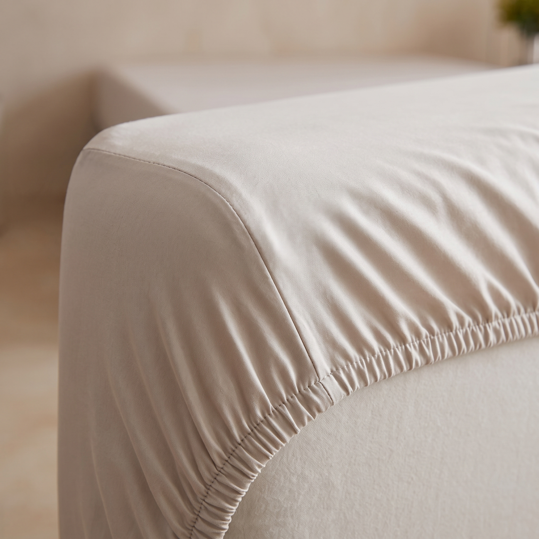 Bamboo Viscose Fitted Sheet Set with Pillowcases in Oatmeal – close-up of the elasticated corner fitted over a mattress