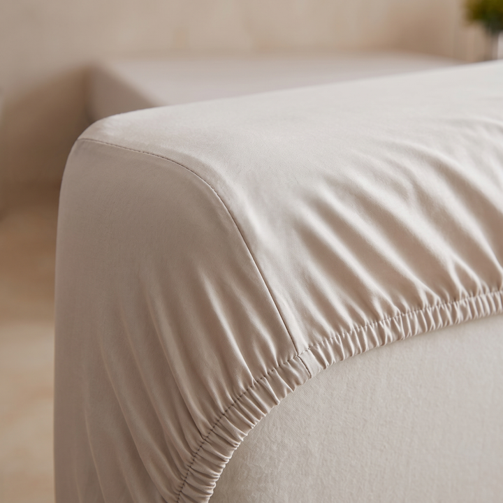 Bamboo Viscose Fitted Sheet Set with Pillowcases in Oatmeal – close-up of the elasticated corner fitted over a mattress