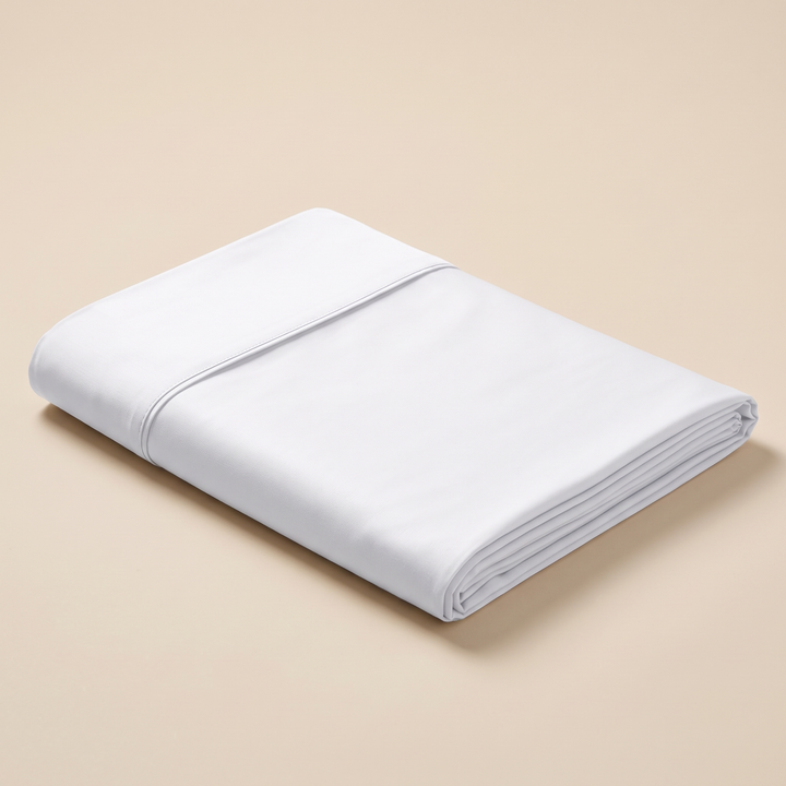Bamboo Viscose Flat Sheet in White – neatly folded stack on a plain beige background