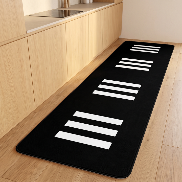 Black and White Runner Rug – Washable in Black – Bar Stripe – stretched along light wood kitchen cabinets on a wood floor
