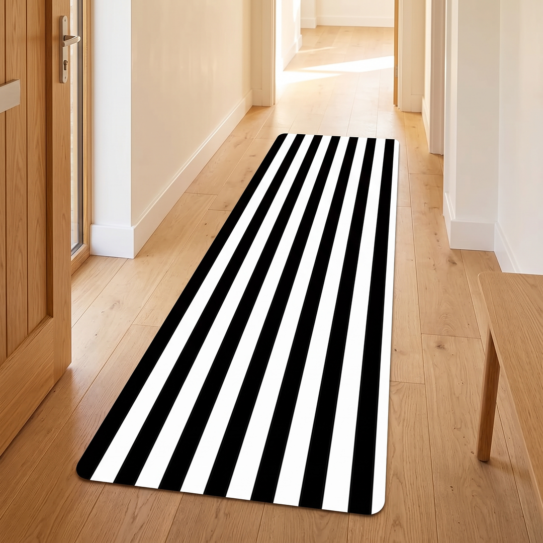 Black and White Runner Rug – Washable in Black &amp; White – Lengthwise Stripe – in an entryway beside a wooden front door and bench
