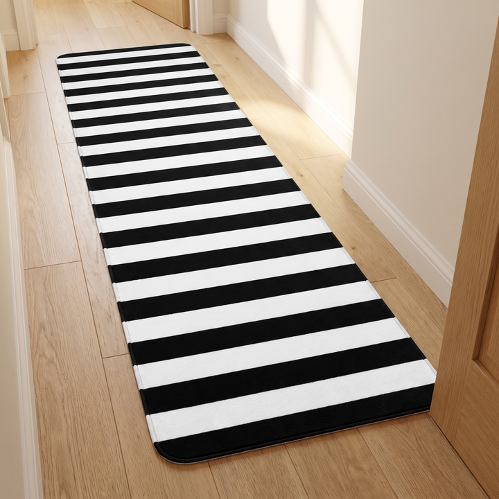 Black and White Runner Rug – Washable in Black &amp; White – Crosswise Stripe – laid on a wood floor in a sunlit hallway