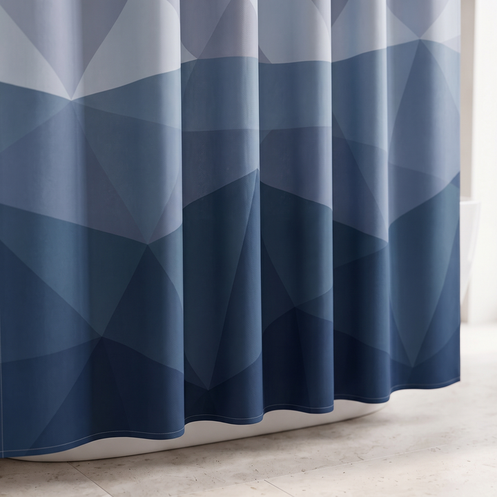 Blue Geometric Fabric Shower Curtain in Blue – close-up of the lower hem hanging beside a bathtub