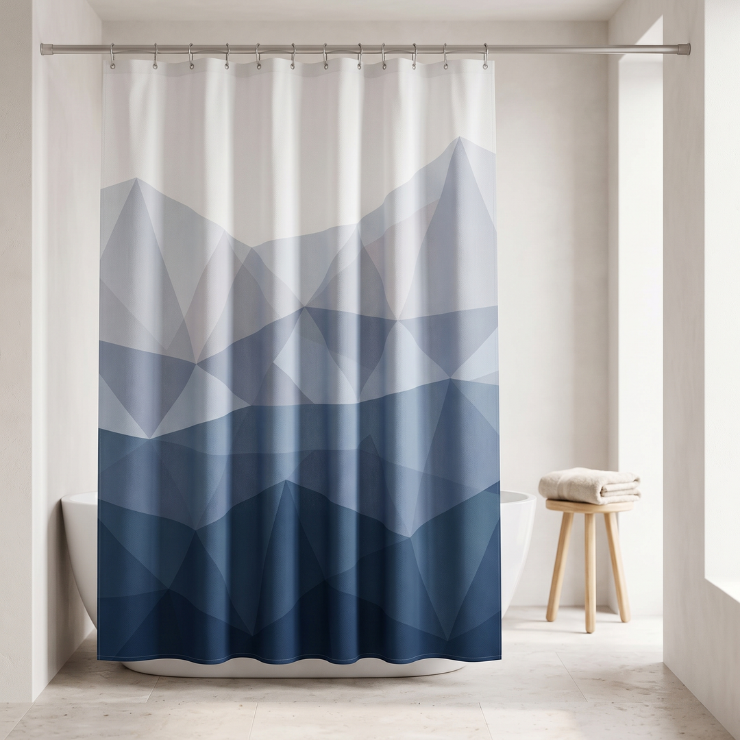 Blue Geometric Fabric Shower Curtain in Blue – hanging from a rod in a bright minimalist bathroom beside a freestanding tub