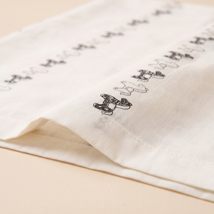 Body Pillowcase – Printed in White Rocking Horse – close-up of the stitched hem and printed horse border