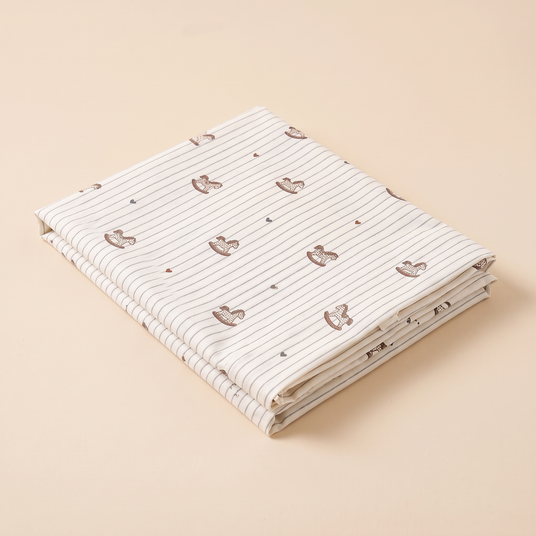 Body Pillowcase – Printed in Cream Rocking Horse – folded stack showing thin pinstripes and tiny hearts scattered between motifs