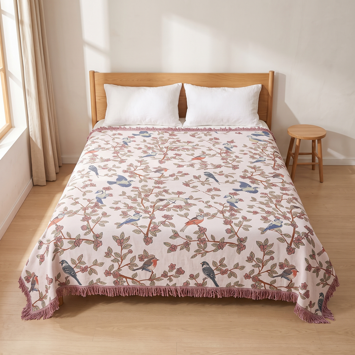 Boho Bird Bedspread – Reversible Gauze with Fringe in Blush – Blossom Birds – top-down view on a wood-framed bed with white pillows