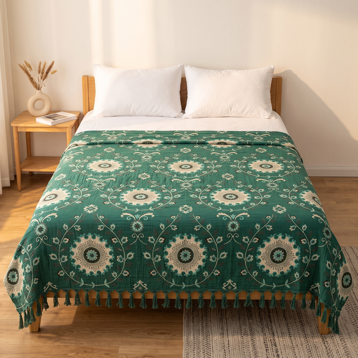 Boho Cotton Muslin Bedspread with Tassels in Forest Green – Medallion – straight-on view across a bed with white pillows and nightstand