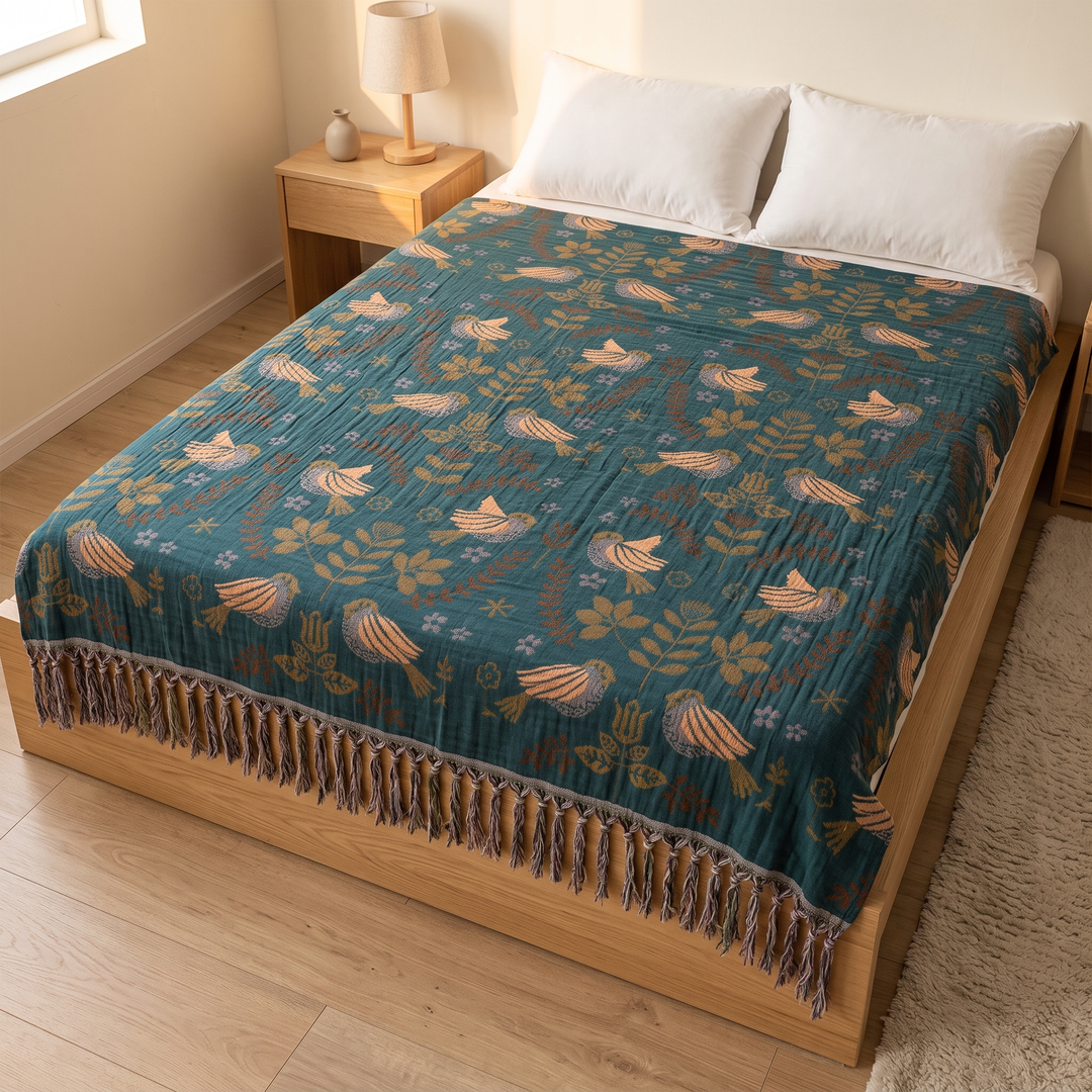 Boho Cotton Muslin Bedspread with Tassels in Teal – Bird – high-angle view of full spread on a platform bed