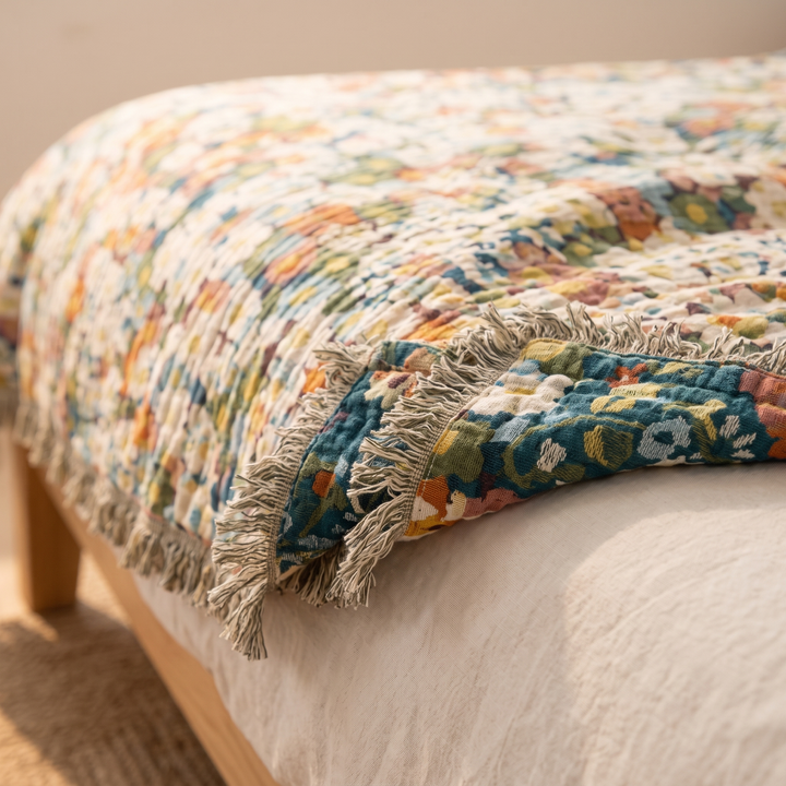 Boho Floral Gauze Bedspread with Fringe in Green Ditsy Floral – close-up of fringed edge folded back over a bed corner