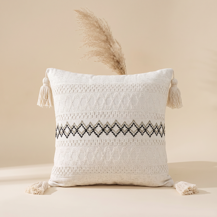 Boho Pillow Cover with Tassels – Woven in Cream – Black Diamond Line – with a dried pampas grass plume rising behind it