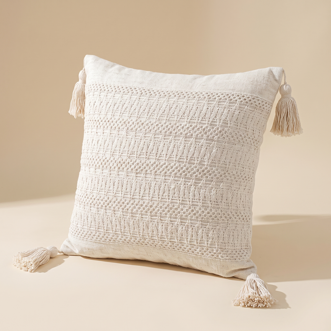 Boho Pillow Cover with Tassels – Woven in Cream – Ribbed – propped on an edge, tassels splayed at all four corners