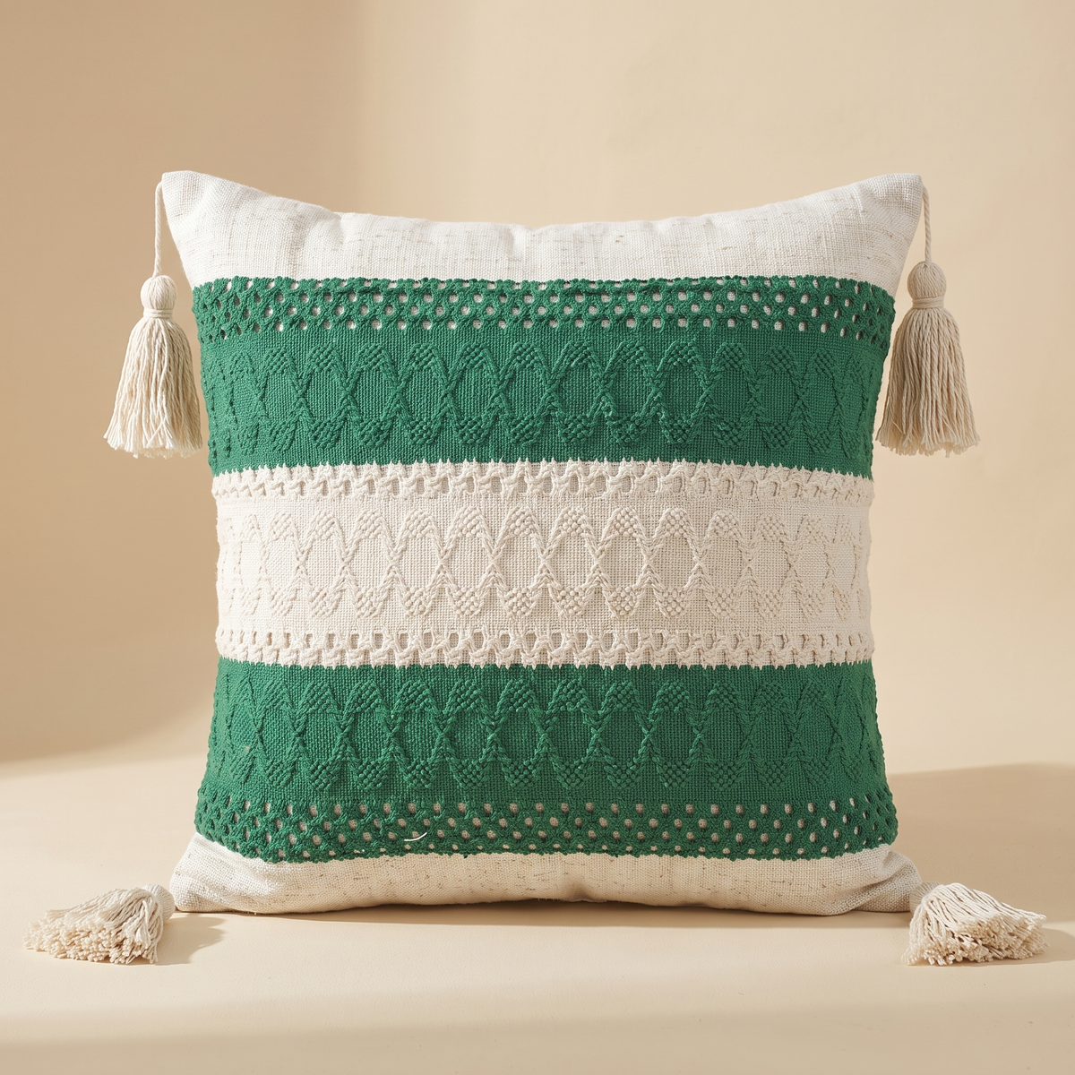 Boho Pillow Cover with Tassels – Woven in Cream – Green Stripe – standing upright against a plain beige backdrop, front view with corner tassels