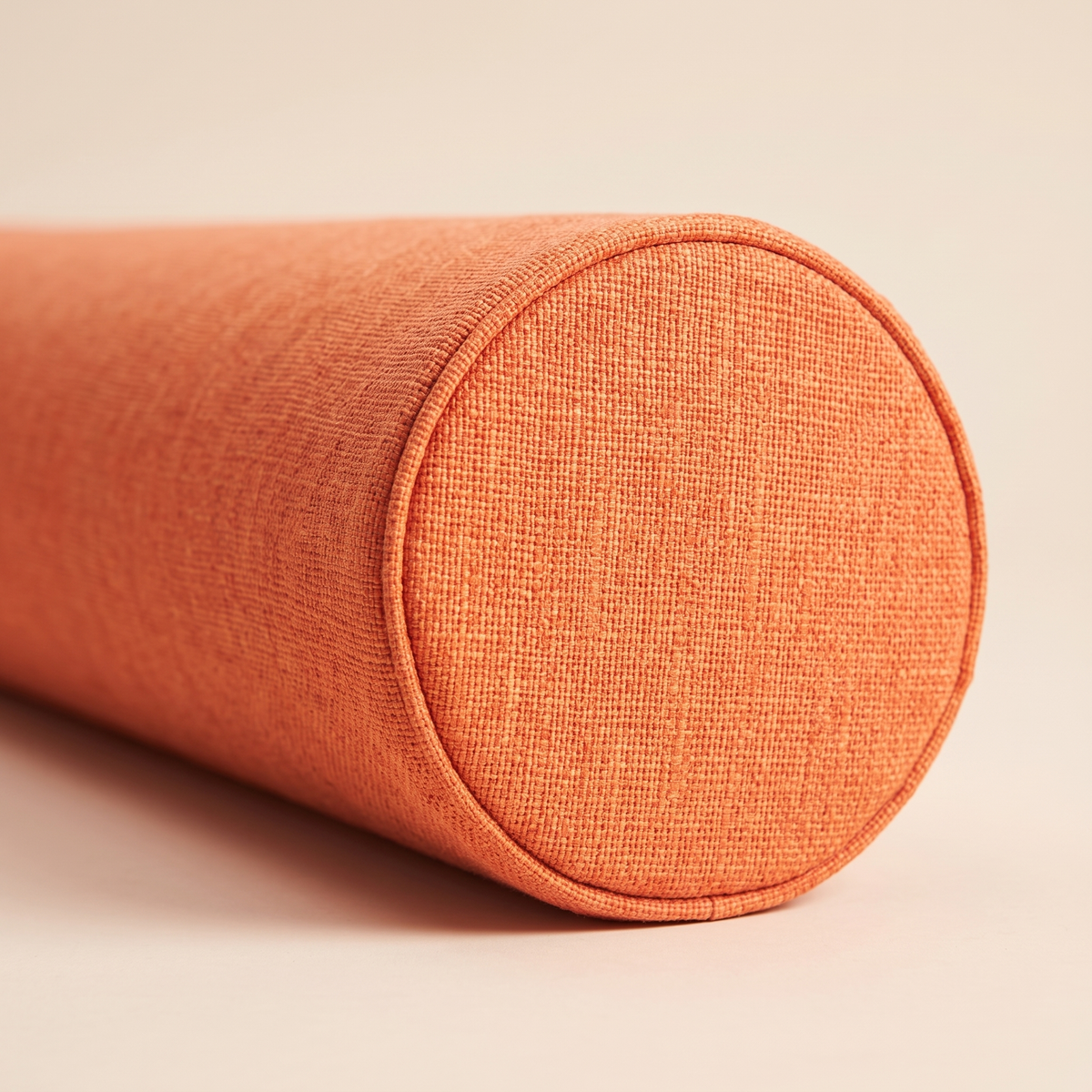 Bolster Pillow in Orange – close-up of the piped end cap and woven texture
