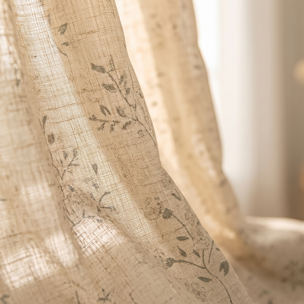 Botanical Sheer Curtain Panel – Linen Look in Beige – close-up of gathered folds with printed leaf branches in window light