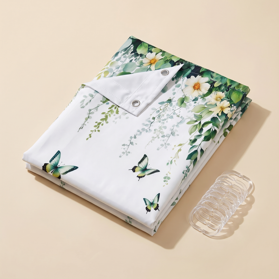 Butterfly Shower Curtain – Watercolor Florals in White – Butterflies &amp; Vines – folded on a beige surface with clear hooks beside it