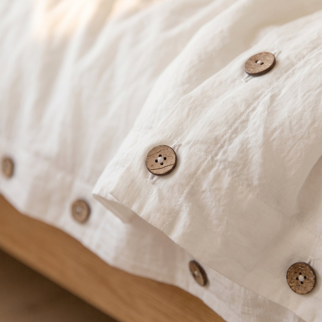 Cotton Duvet Cover Set with Buttons in White – close-up of coconut buttons along the cuff edge