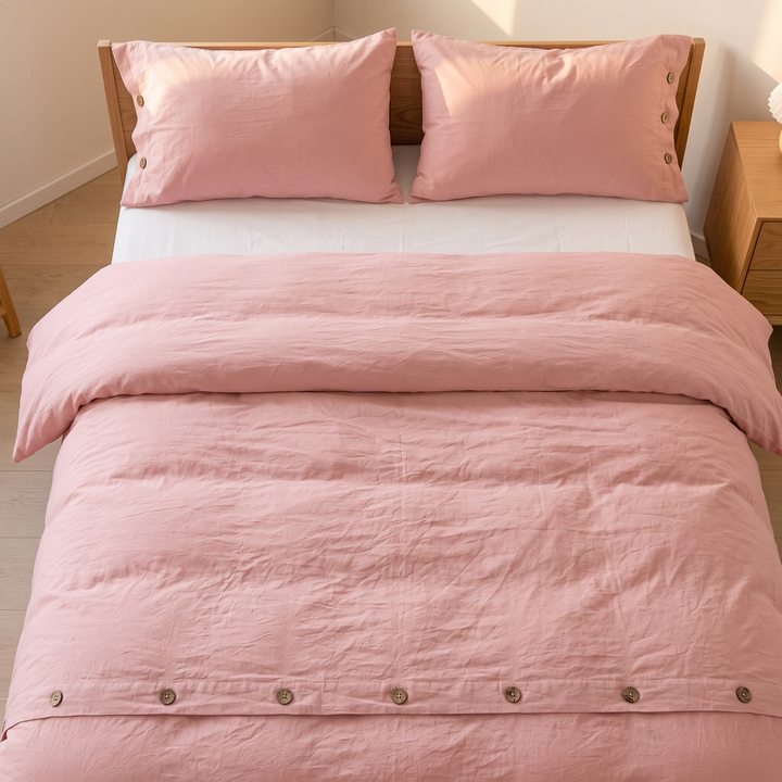 Cotton Duvet Cover Set with Buttons in Dusty Pink – viewed from the foot of the bed, buttons in foreground