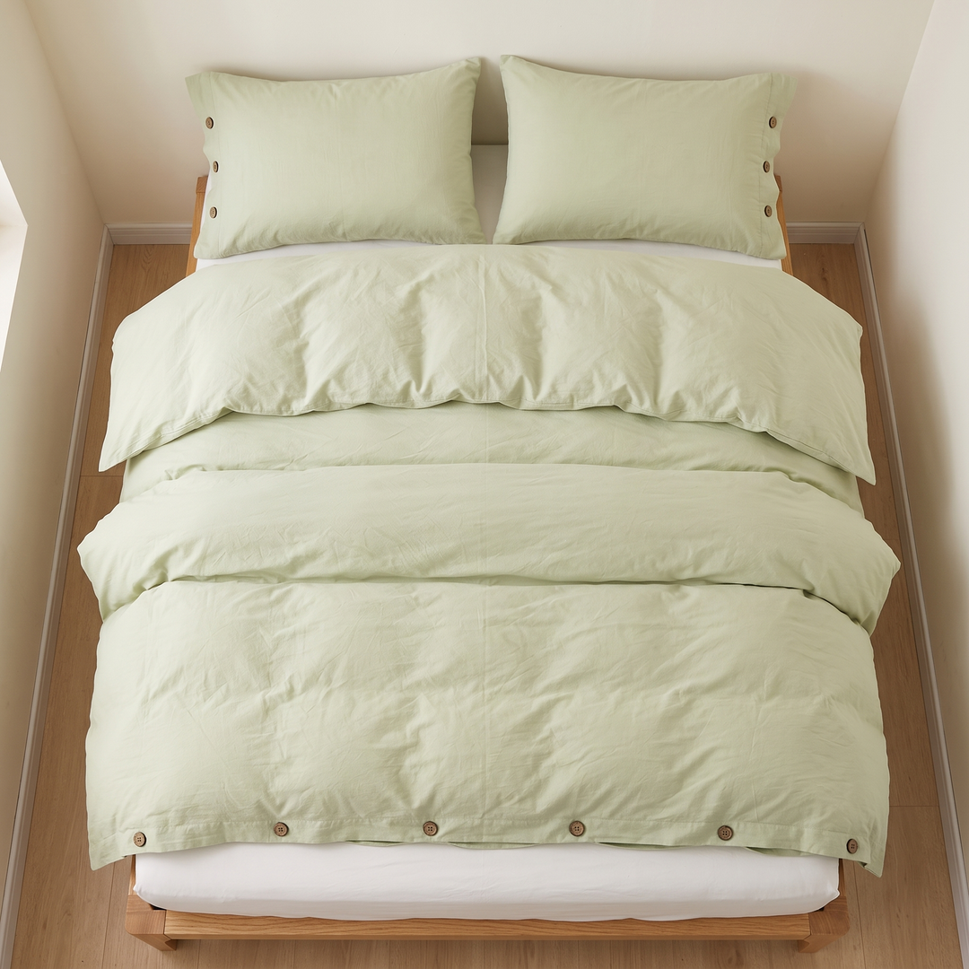 Cotton Duvet Cover Set with Buttons in Light Green – made bed tucked into an alcove with wood flooring