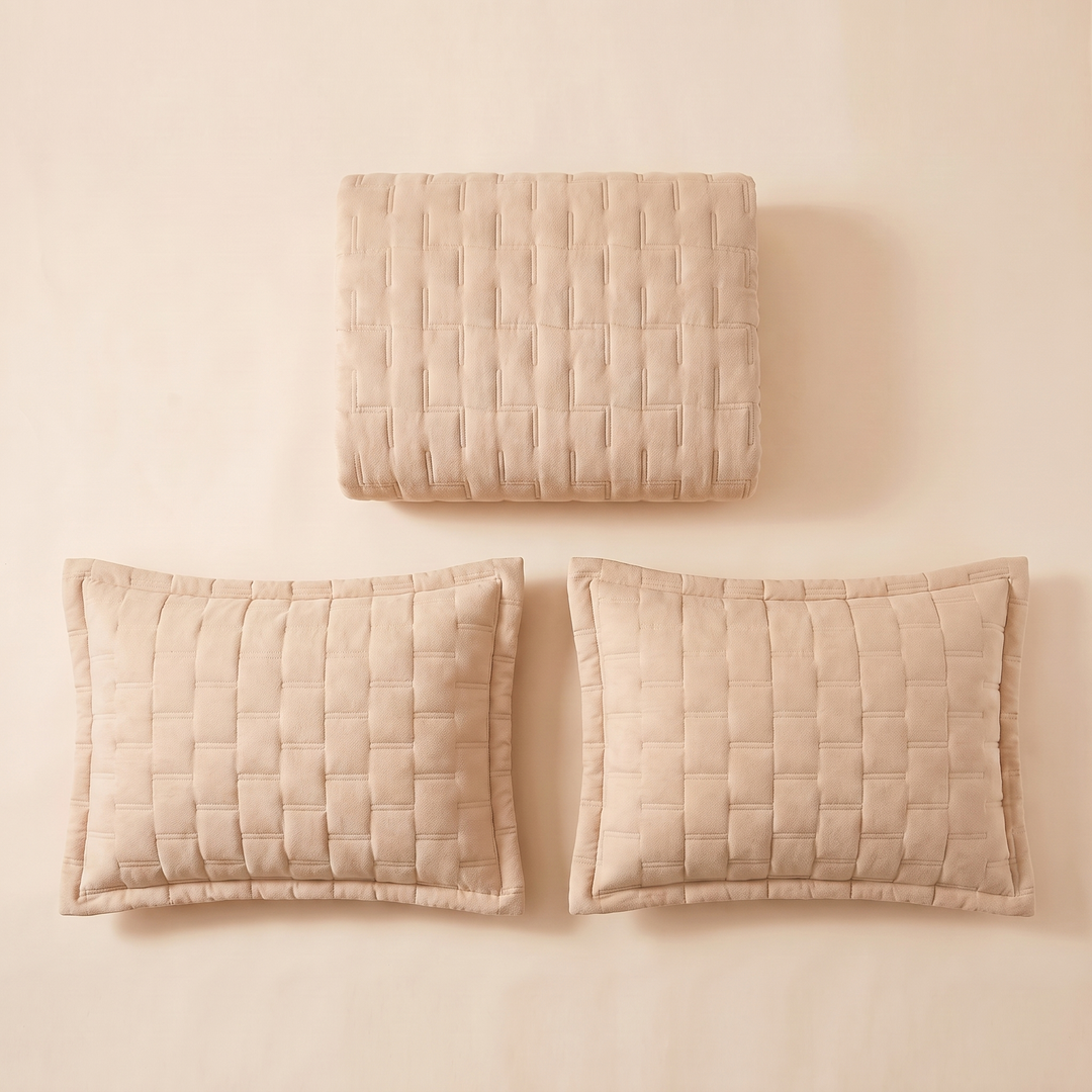 Channel quilted bedspread folded with its 2 pillow shams