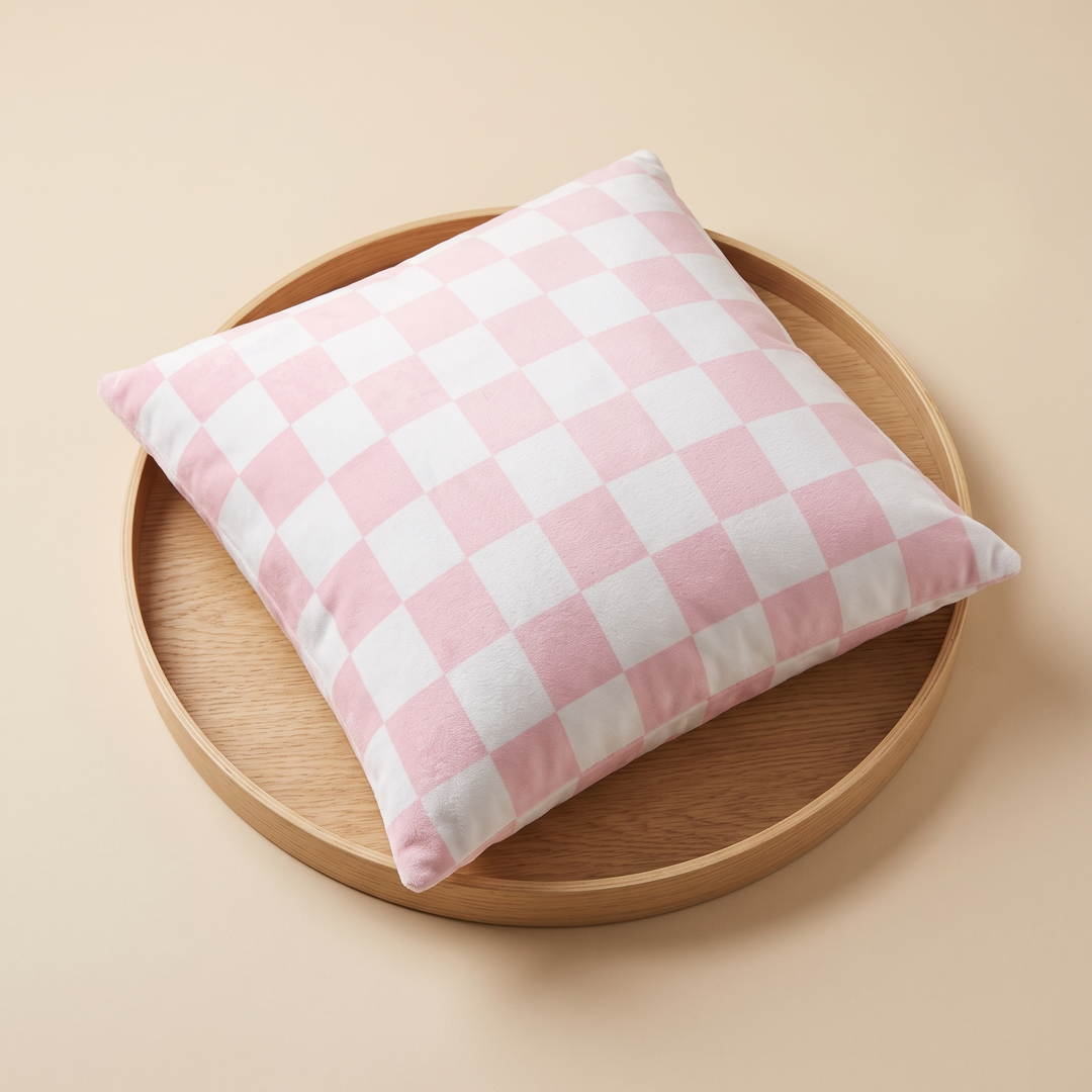 Checkered Pillow Cover in Light Pink &amp; White Check – lying flat on a round wooden tray, seen from above at an angle