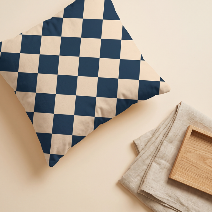 Checkered Pillow Cover in Navy &amp; Sand Check – flat lay from above beside folded linen and a wooden tray