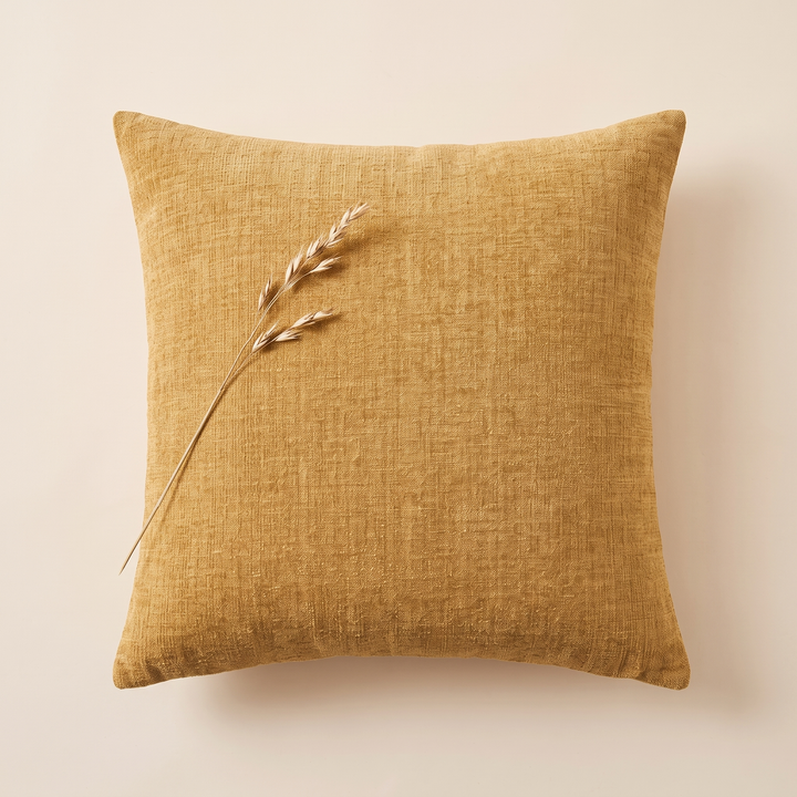 Chenille Throw Pillow Cover in Mustard – overhead view with a dried grass stem laid on top