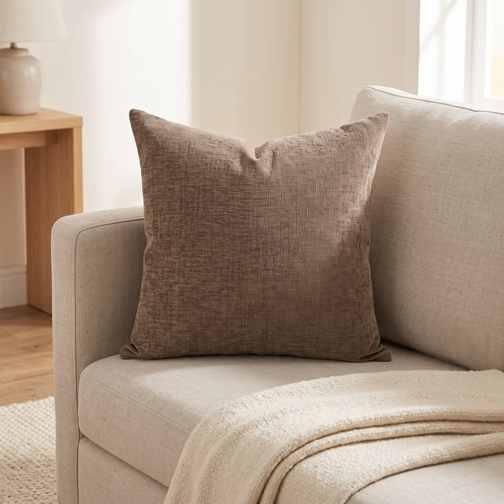 Chenille Throw Pillow Cover in Chocolate Brown – propped on a beige sofa corner beside a cream knit throw