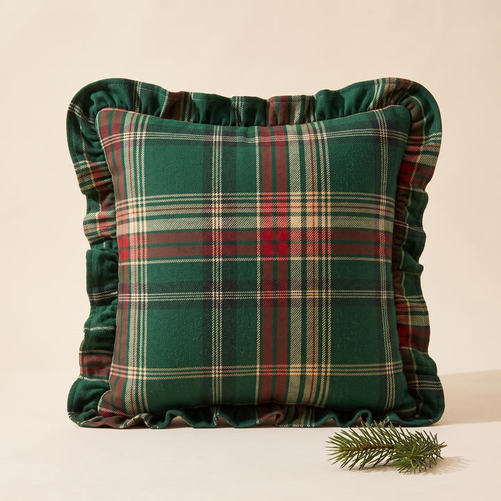 Christmas Plaid Pillow Cover in Green – Tartan – propped upright with a small pine sprig beside it