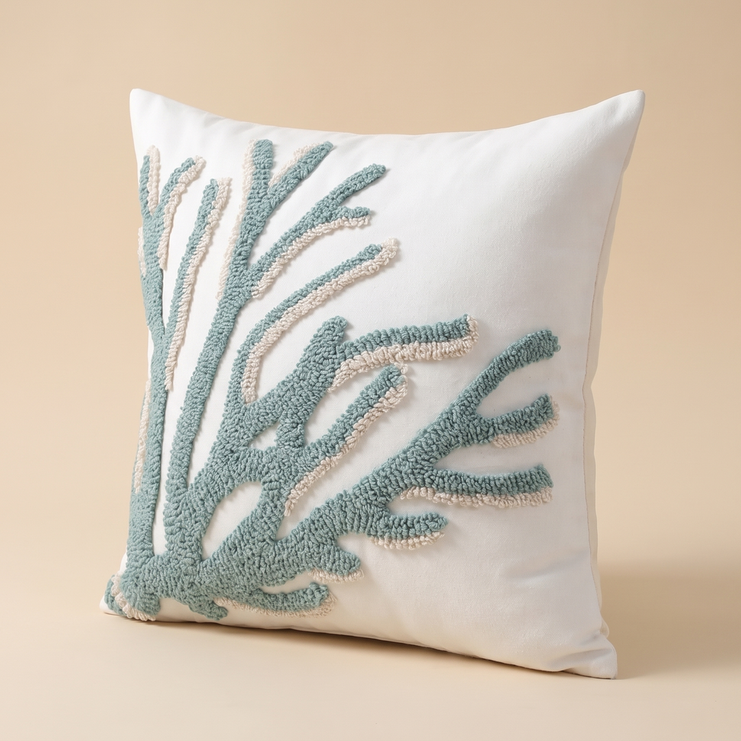 Coastal Throw Pillow Cover – Tufted in Sea Green – Branch – angled front view standing upright against a plain peach studio backdrop