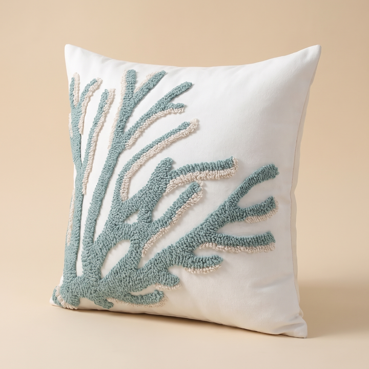 Coastal Throw Pillow Cover – Tufted in Sea Green – Branch – angled front view standing upright against a plain peach studio backdrop