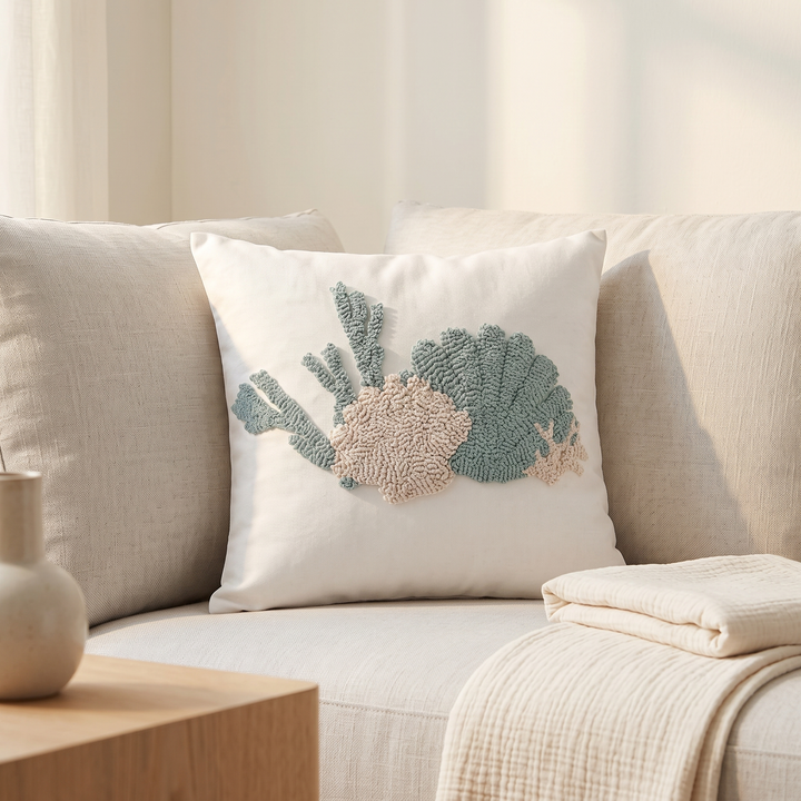 Coastal Throw Pillow Cover – Tufted in Sea Green – Shell – styled on a cream sofa beside a folded throw blanket