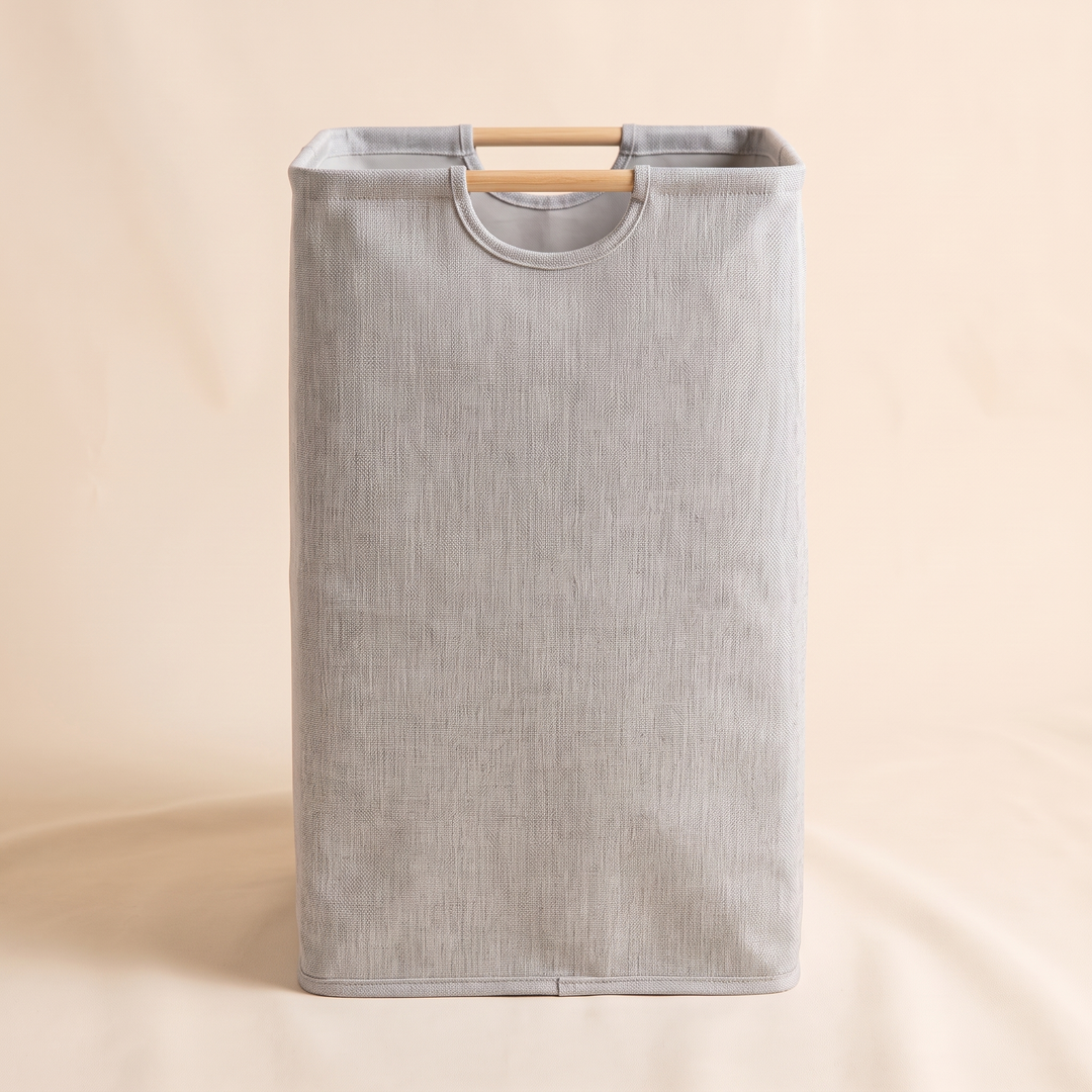 Collapsible Laundry Basket in Gray – full height centered on a softly draped fabric sweep