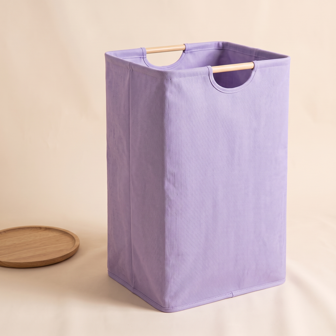 Collapsible Laundry Basket in Lilac – standing upright next to a round wooden tray on the floor
