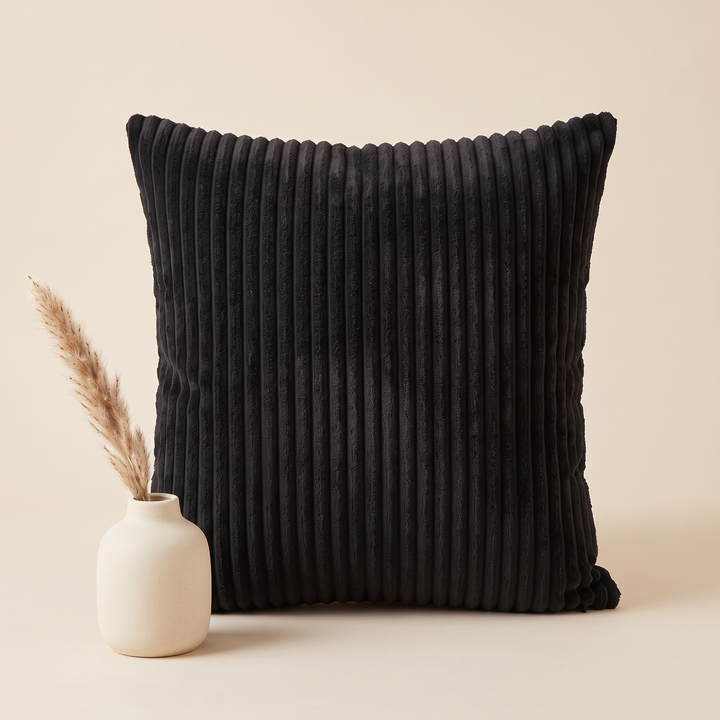 Corduroy Pillow Cover in Black – beside a small ceramic vase holding dried pampas grass