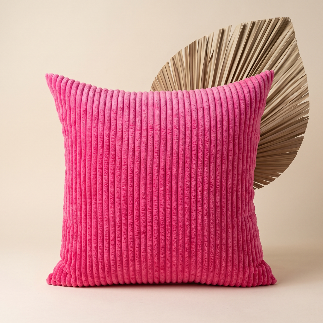 Corduroy Pillow Cover in Hot Pink – upright in front of a dried palm leaf on beige