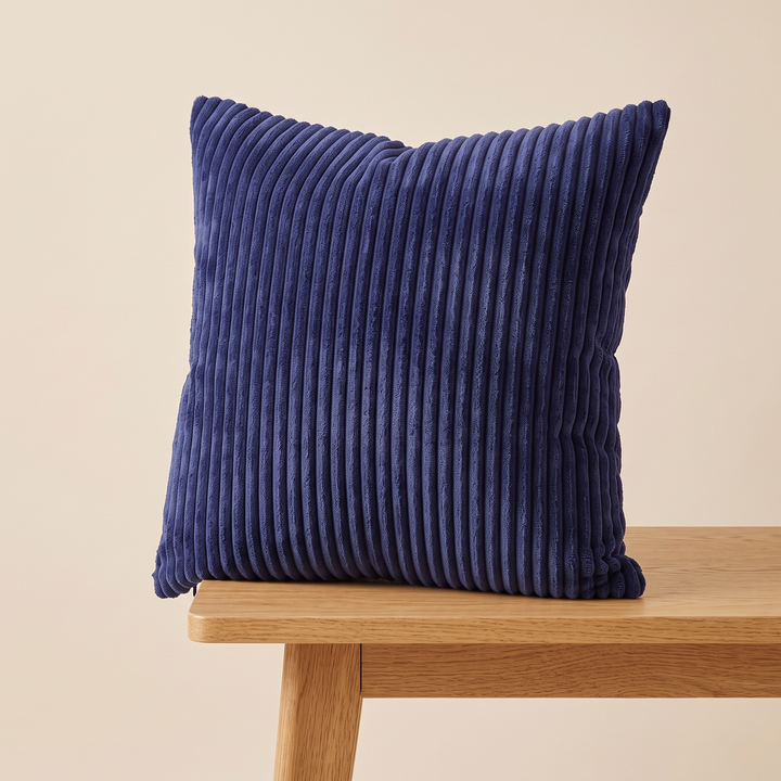 Corduroy Pillow Cover in Indigo – on a wooden bench, bench leg and rail visible