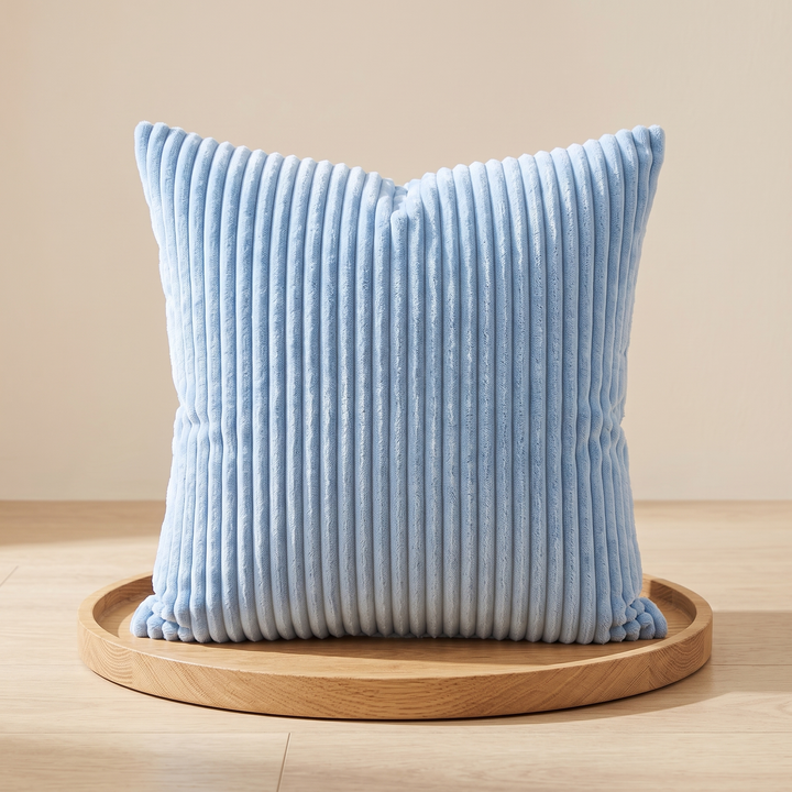 Corduroy Pillow Cover in Light Blue – standing on a round wooden tray on a wood floor