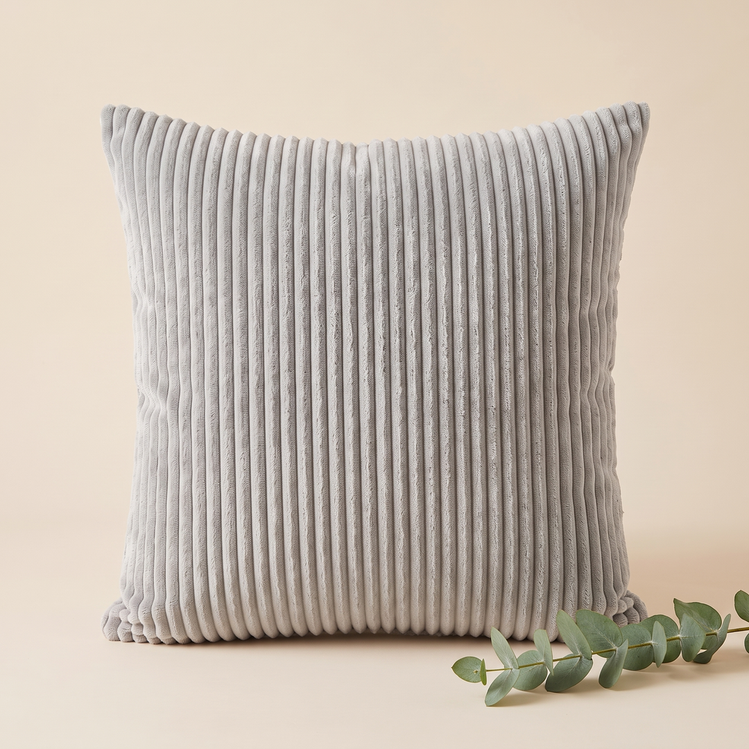Corduroy Pillow Cover in Light Gray – styled with a eucalyptus sprig at the lower right