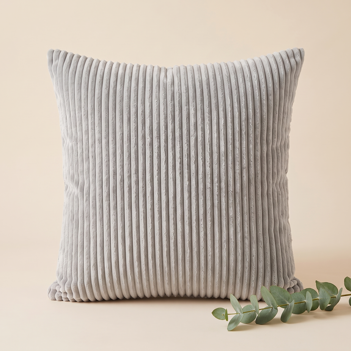 Corduroy Pillow Cover in Light Gray – styled with a eucalyptus sprig at the lower right