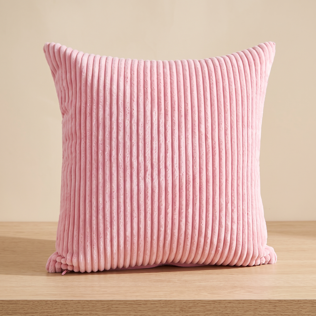 Corduroy Pillow Cover in Light Pink – centered on a wood tabletop, zipper at bottom left corner