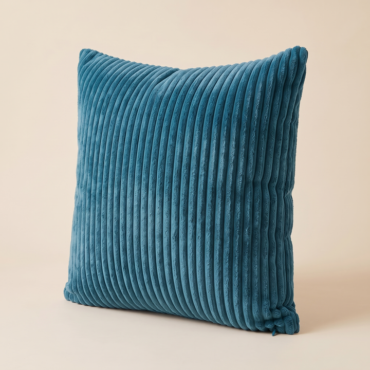 Corduroy Pillow Cover in Teal Blue – angled right-hand view with ribs running vertically on cream backdrop