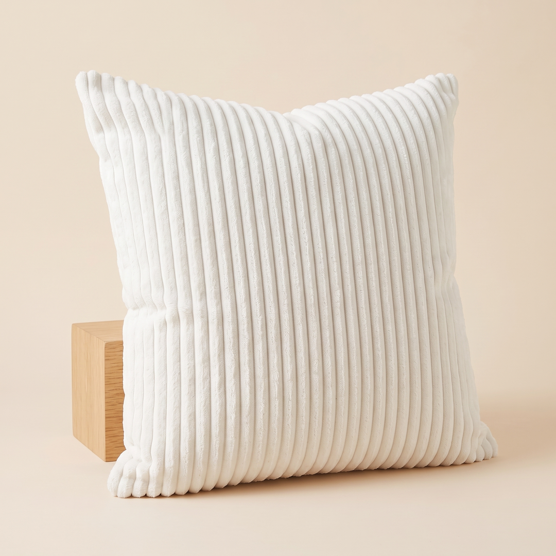 Corduroy Pillow Cover in White – propped against a light wooden block on a plain backdrop